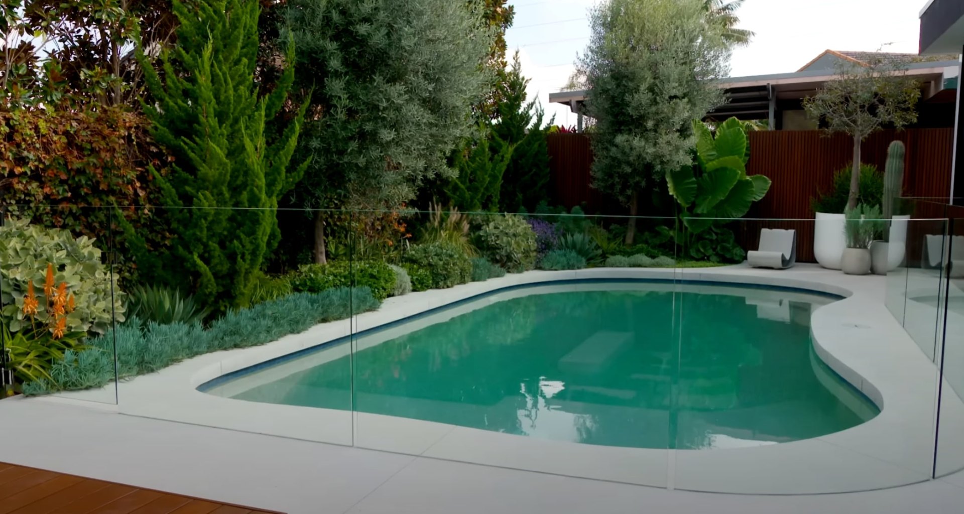 Modern backyard with swimming pool and professional landscaping design